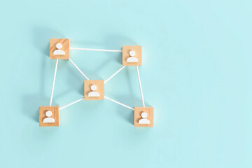 Wooden Cubes Connected with Lines on Blue Background Representing Social Network and Organizational Structure, Illustrating Teamwork, Digital Communication, and Business Collaboration
