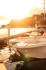 view of the stern of a white yacht at sunset