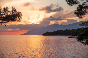 sunset on the seashore with a view of the mountains in makarska riviera croatia