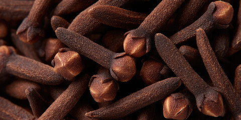 Cloves are shown in a close-up, highlighting their textured surface and unique shape. Spices and flavoring ingredients