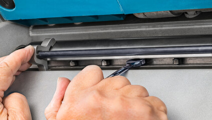 Craftsman hands detail at adjusting plane rotary steel blade by metal spanner. Closeup maintenance of woodwork planing tool for thickness reduce and smooth surface of wood at shaping planks or boards.