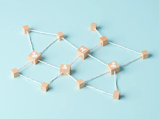 Wooden Cubes Connected with Lines on Blue Background Representing Social Network and Organizational Structure, Illustrating Teamwork, Digital Communication, and Business Collaboration