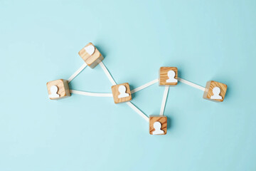 Wooden Cubes Connected with Lines on Blue Background Representing Social Network and Organizational Structure, Illustrating Teamwork, Digital Communication, and Business Collaboration