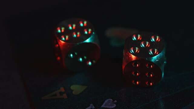 Casino games background with playing cards and dice for playing various games of chance on black table.