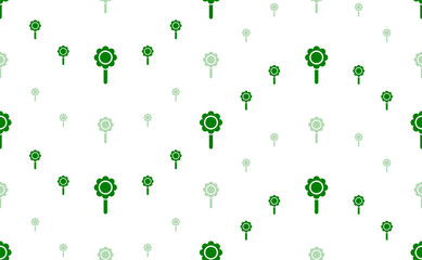 Seamless pattern of large and small green chamomile symbols. The elements are arranged in a wavy. Illustration on light green background