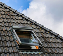 Open roof window is letting fresh air into the attic