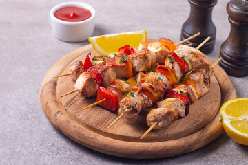 Delicious grilled chicken skewers with capsicum, lemon, salad and ketchup on a plate over the table. Chicken kebab. Healthy food concept.