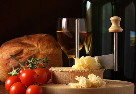 Retro Still life of Swiss Cheese Specialty Tete de Moine in low key tone