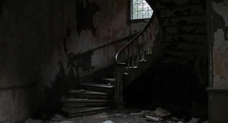 Dark stairway with a broken railing