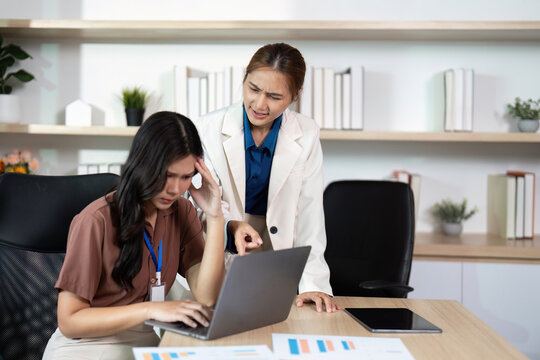 Problem Solving in the Workplace. A stressed woman receiving guidance from her colleague.