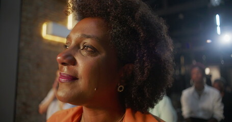 Tearful woman smiling during worship, deeply moved by faith and spirituality, illuminated cross in...
