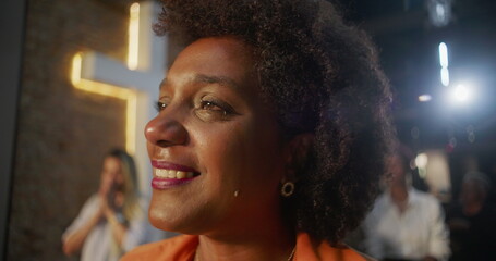 Tearful woman smiling during worship, deeply moved by faith and spirituality, illuminated cross in...