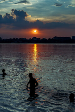 silhouette of a man in the river
