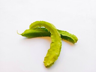 Winged beans on a white background. two winged beans isolated on a white background. a tropical legume with distinctive four-angled pods.