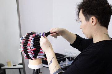 Perm training on a mannequin at the school of hairdressing.