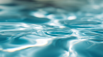 Blue water surface with gentle ripples and sunlight reflections, an abstract aquatic serenity.