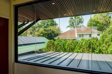 Fototapeta premium View from the window and the tree in summer,roof of house,cozy indoor home living room.