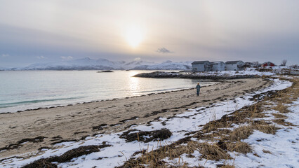 Woman relax in sunset on the beach, Fishing village by the sea under overcast skies, the veil...
