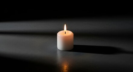 burning candle on black background