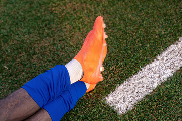 Close-up of soccer player's foot in cleats on the field before a game