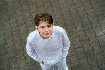 Portrait of smiling teenage schoolboy looking at camera. Happy teenage boy, smiling confidently...