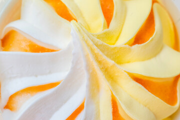 Close-up of colorful ice cream swirl with white and yellow cream. Perfect for food ads, menu design, packaging or summer-themed visuals.