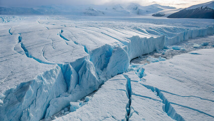Massive Polar Glacier With Cracks And Crevasses In Winter