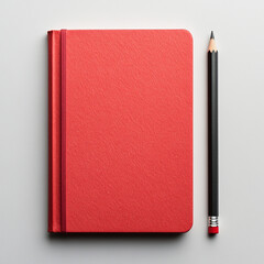 A red notebook with a pencil on a white background.