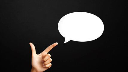 Hand pointing at empty white speech bubble. - blank  space to copy.