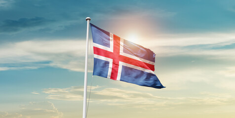 Iceland national flag waving in beautiful sky with mast. A proud moment flag waving with sunlight.