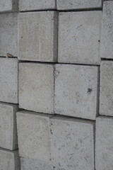 A variety of concrete products—triangular bricks, cylindrical pipes, and rectangular blocks—neatly arranged and ready for use in construction and infrastructure projects. These materials reflect durab