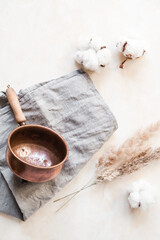 Natural self-care flat lay with a copper vessel, herbs, essential oil, and wooden tools. Herbal rituals, sustainable wellness, and plant-based remedies in earthy, apothecary style