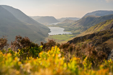 View of Buttermere and surrounding mountains on a sunny spring afternoon in The Lake District National Park, UK.