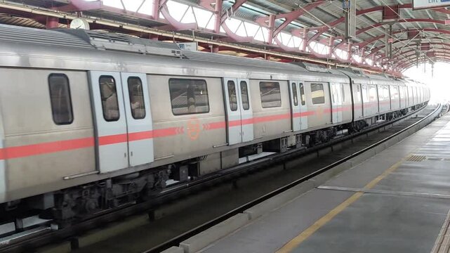 New Delhi, India, August 12 2024 - Delhi Metro train arriving at Jhandewalan metro station in New Delhi, India, Asia, Public Metro departing from Jhandewalan station