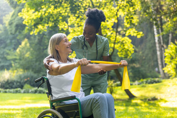 Nurse with a female patient on a wheelchair in the park