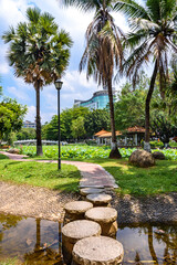 Beautiful summer scene at Caotang Park in Dongguan, China. Stepping stones on the pond.