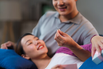 Boyfriend surprising girlfriend with an engagement ring during a heartfelt marriage proposal, capturing a joyful moment of love and commitment