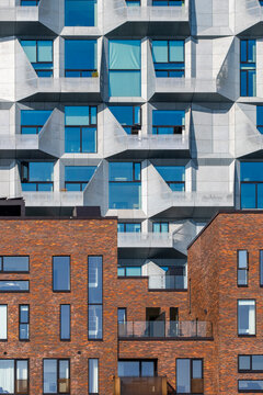 Glass and metal facade in Copenhagen with a uniform window pattern, architectural minimalism in a clean format, useful for backgrounds and structural design themes.