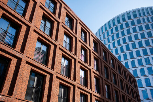 Architectural symmetry with rectangular windows on a modern building in Copenhagen, clean structure captured in soft overcast light from a centered composition.
