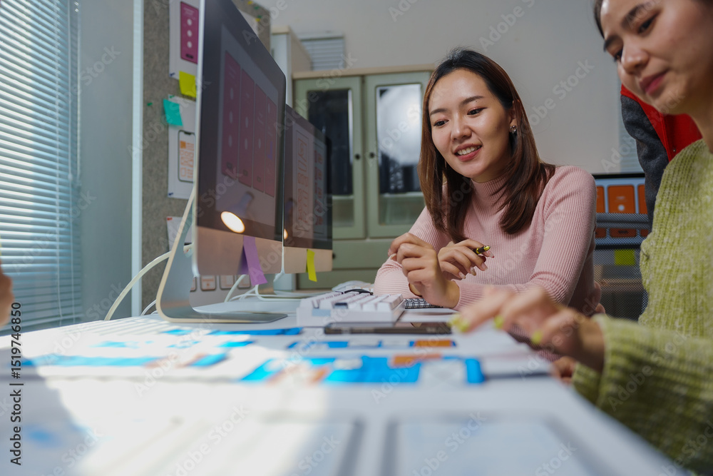 Aufkleber two female web designers collaborating on user interface design during a meeting in a modern office,