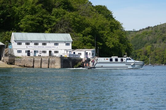 The Royal Navy Maritime Training Area building overlooking The Royal Navy Sea Class Officer Training Boat Cormorant on The River Dart, Dartmouth, Devon, England, UK. May 2025. 