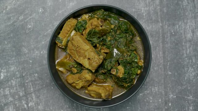 Spicy pork bone curry with betel leaves and rice, a local dish from southern Thailand.