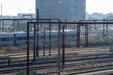 Elevated railway view of multiple train tracks in Copenhagen with urban skyline and morning light, highlighting infrastructure and transportation geometry for commercial cityscape content.