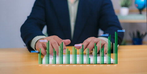 Businessman analyzing company growth using a laptop and tablet, with current and future business growth graphs, development strategies, and financial information for long-term investment planning.