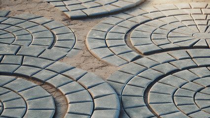 Interlocking Circular Pavers on a Sandy Surface