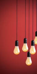 Creative arrangement of illuminated lightbulbs against a bright bold modern red abstract backdrop