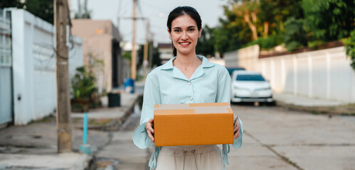 A woman receives a package during rush hour outside her home.