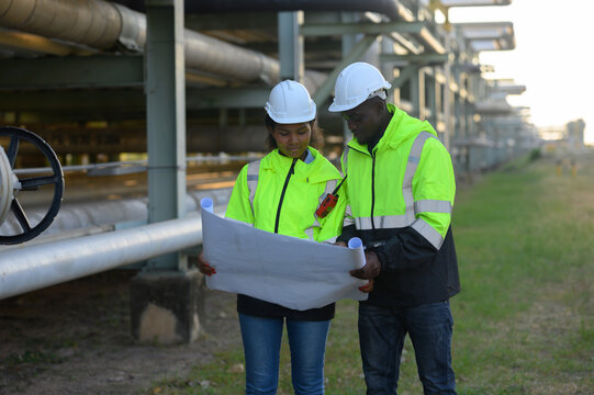 Male and female engineers are checking the integrity and safety of a gas energy pipeline.