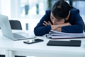 young businesswoman Wearing a suit bending over the table