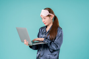 Asian wearing Pajamas Entrepreneur Notebook Social Lady Working Online, A Young Businesswoman in Casual Style Using Laptop for Work and Study in a Modern, Relaxed Setting
